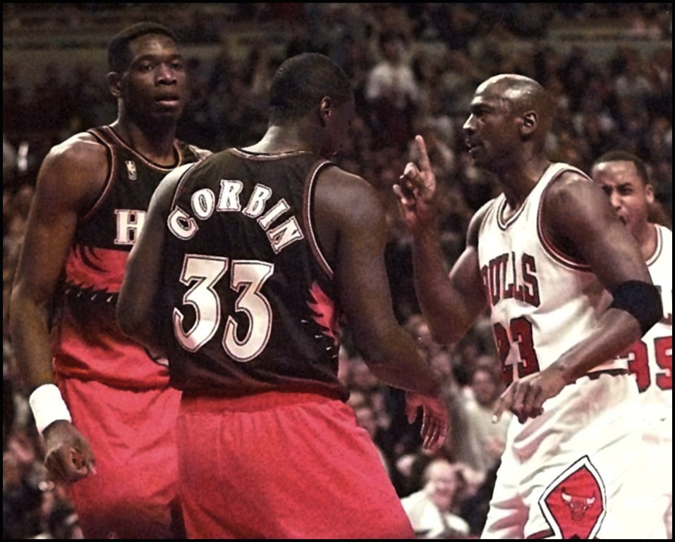 Mutombo of Atlanta Hawks facing Michael Jordan (R) of the Chicago Bulls